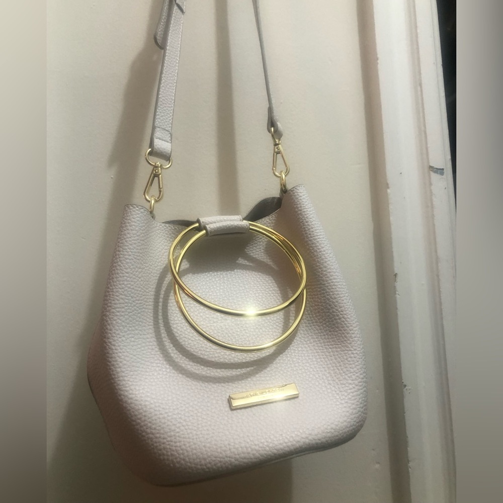 Katie Loxton- Round pebbled bag w gold handheld or removable cross body strap.